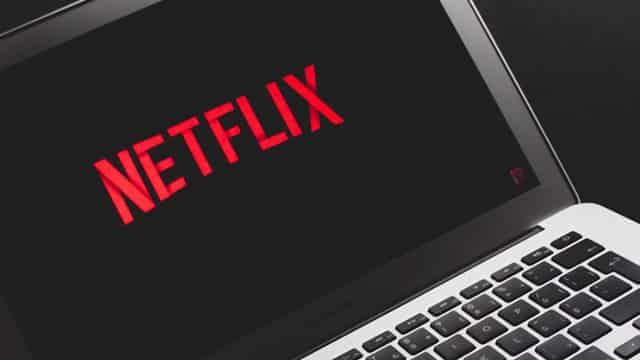 As Hollywood reels, Netflix's streaming lead is intact ahead of earnings. Analysts say to expect price increases this year